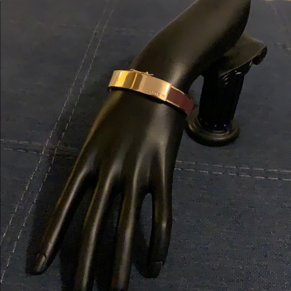Coach gold and burgundy/brown color bracelet.